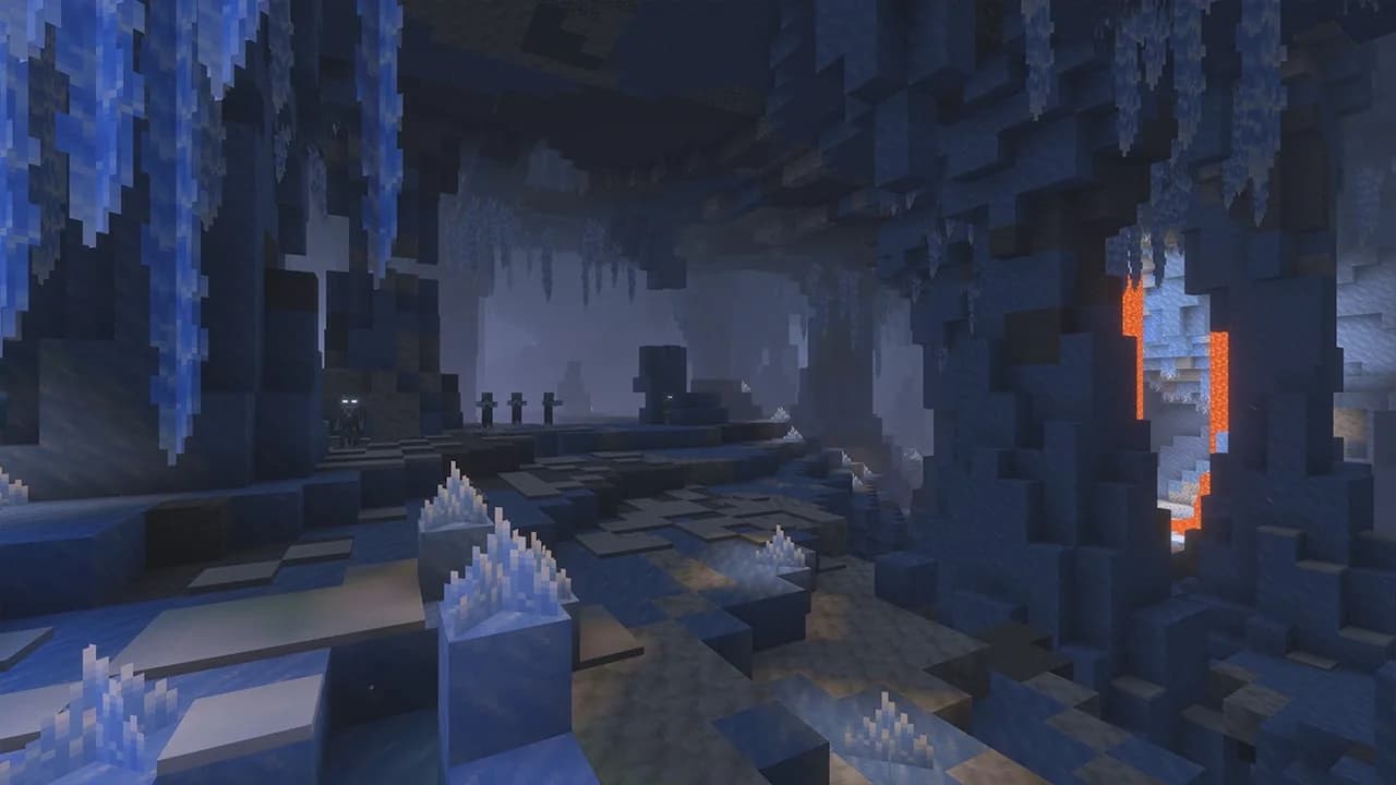 Mojang's preview of a blue ice cave with hanging icicles, pale crystals on the floor, distant mobs and a lava-lit opening.
