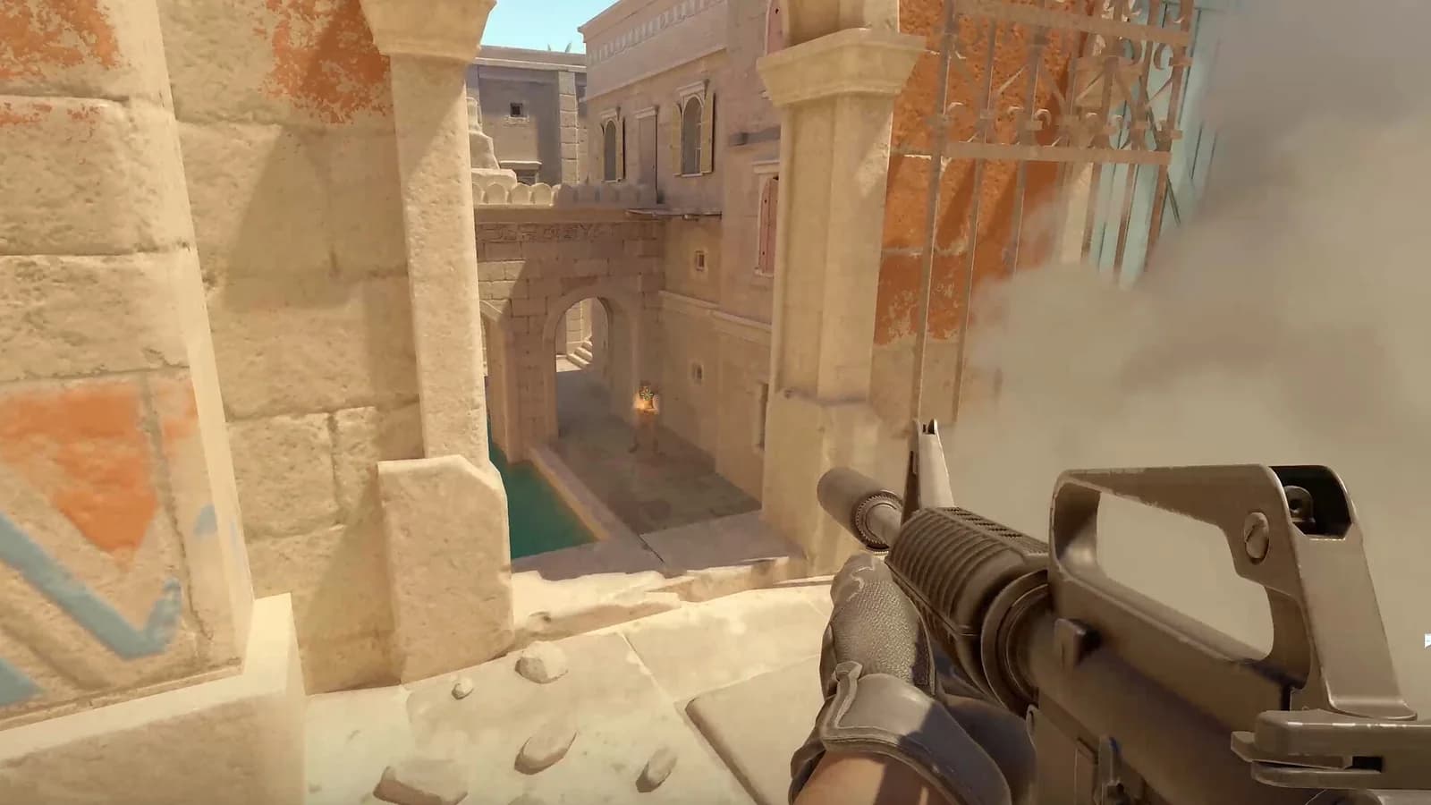 A Counter-Strike 2 player holds a rifle while looking down a sunlit stone passage, with smoke obscuring the right side.